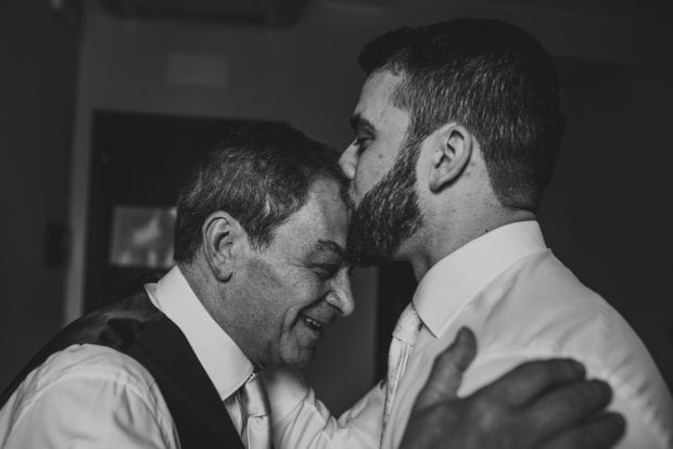 Lo sposo bacia il padre sulla fronte in un gesto di affetto prima del matrimonio a Villa Bossi.