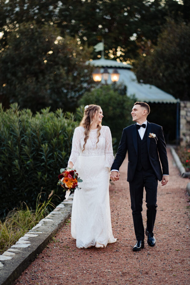 Sposi camminano sorridenti nei giardini di Villa Malliana da Paolo Lamperti