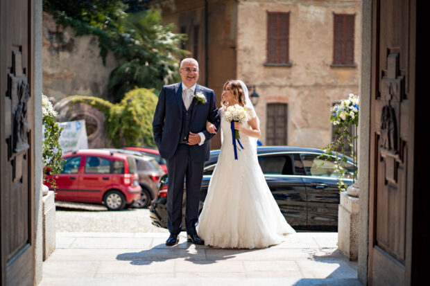 La sposa entra in chiesa accompagnata dal padre prima della cerimonia al Castelletto di Corbetta.