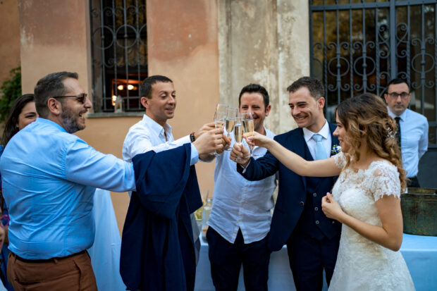 Gli sposi brindano con gli amici al Castelletto di Corbetta per celebrare il matrimonio.